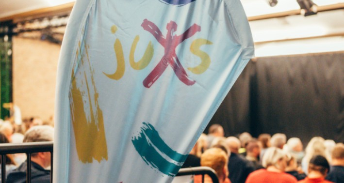 Das Foto zeigt eine Beachflag mit der Aufschrift Juxs.
