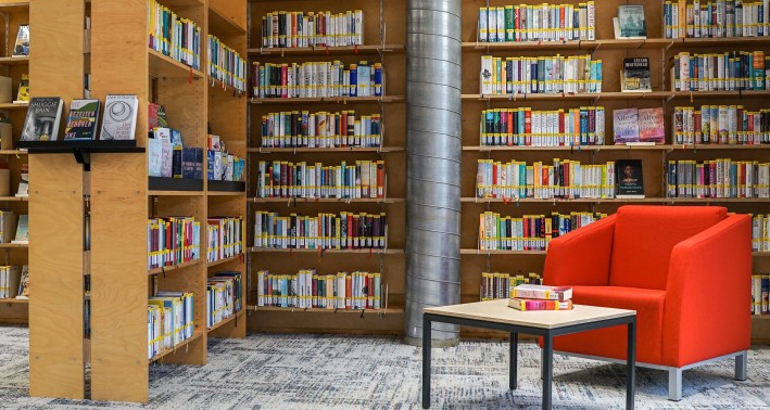 Roter Sessel vor gefüllten Bücherregalen