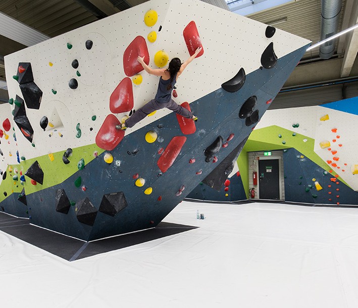 Boulderhalle mit kletternder Person