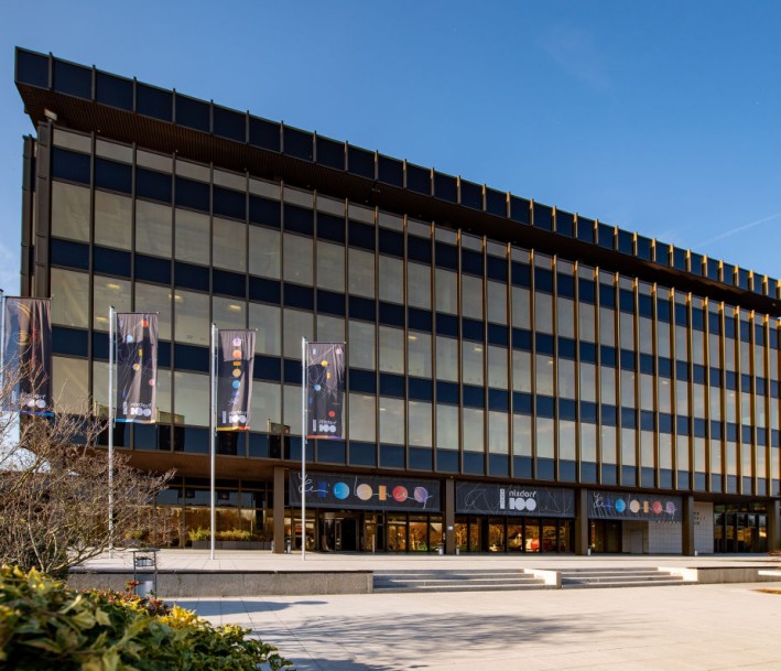 Foto: Sergei Magel, Heinz-Nixdorf-Forum Das Gebäude des Heinz-Nixdorf-Forums mit Flaggen in der Sonne